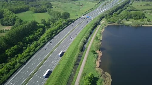 Aerial footage of the highway near the lake in Europe/Holland in 4K