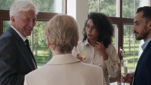 Business People Having Conversation at Small Party