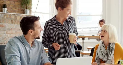 Young Adults Collaborate in Modern Workplace Office