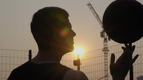 Basket Ball Balancing and Spinning on a Finger. Urban Scene of Street