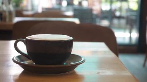 Enjoying a Warm Cup of Coffee in a Cozy Cafe