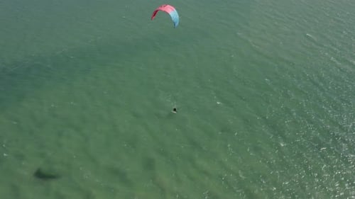 Red Kite Parachute Pulls Surfer on Fuzeta Ocean Waters during Magnificent Sunset, Drone Aerial
