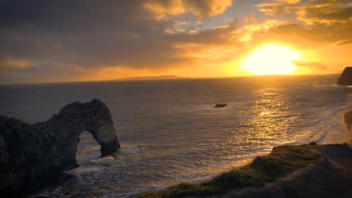An amazing view of sunset from the cliffs of Durdle door, Dorset, England showing natural limestone
