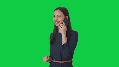 Happy Indian girl talking to someone on call Green screen
