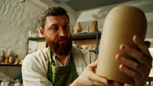 Artist Shaping Clay Figure in Studio