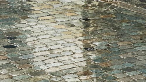 Raindrops Splash On Wet Cobblestone Street Surface