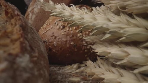 Rustic Bread and Ears of Wheat on the Old Vintage Table