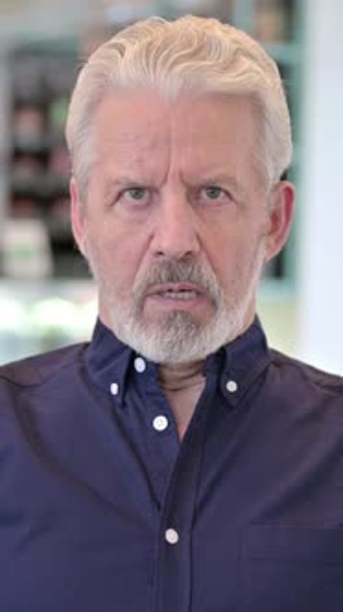 Man with Gray Hair Looking Directly into Camera