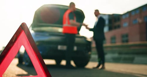 Men Inspecting Broken Vehicle on the Roadside