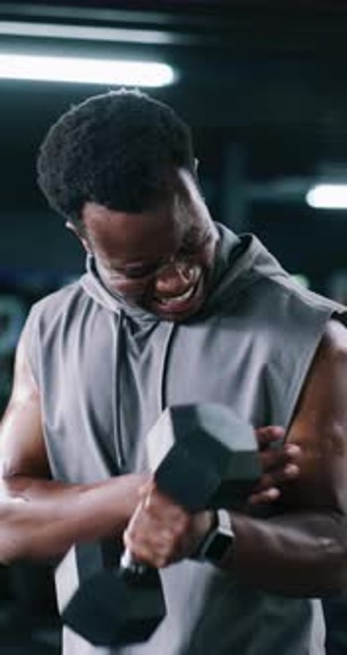 Dumbbell, injury and muscle with man in gym for accident, fitness cramp or training fatigue