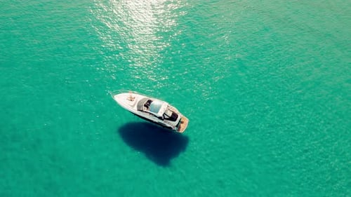 Small boats and yachts anchored and floating through the turquoise waters of the mediterranean sea