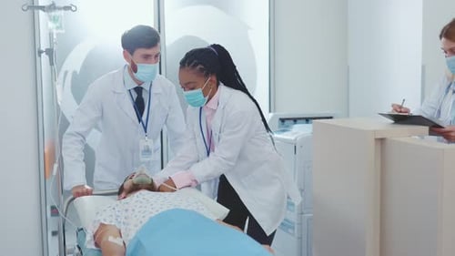 A Dedicated Medical Team is Attentively Attending to a Patient in a Hospital Room Setting