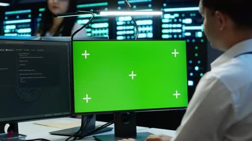 Employee Using Green Screen Devices in Server Farm Used for Automation