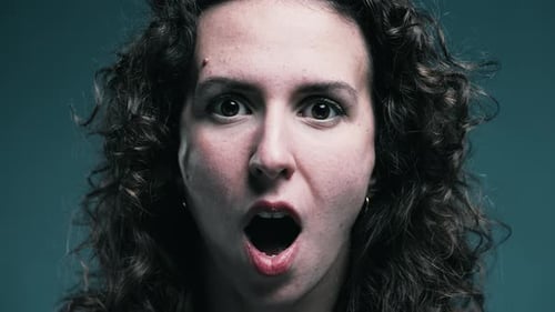 Woman With Shocked Expression Looking at Camera