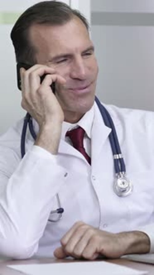 Doctor Talking on Cell Phone in Office