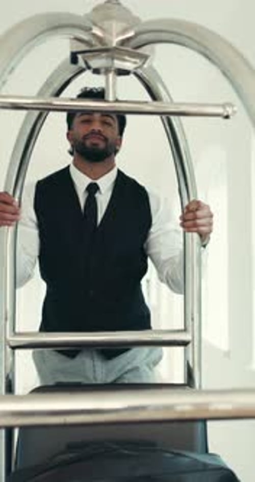 Porter, smile and luggage with man in hotel for hospitality, valet service and baggage handler