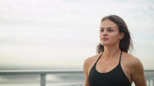 Fit Woman Jogging Outdoors in Black Sports Bra