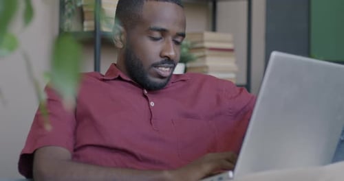 Male Student Using Laptop Studying in Online School Concentrated on Educational Course in Internet