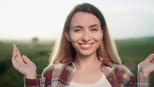 Woman Smiles and Removes Hands From Eyes