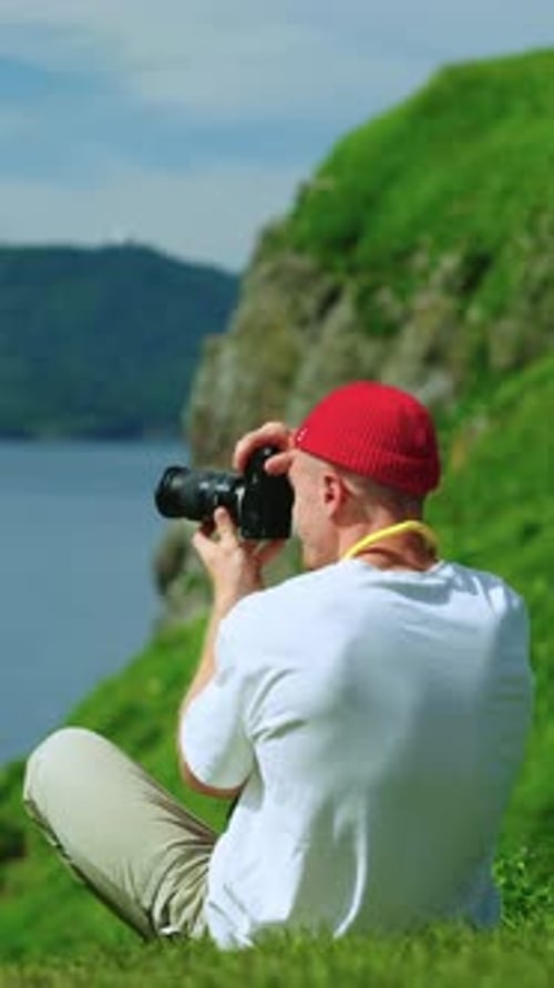 A Passionate Photographer Captures the Natural Beauty of a Lush Landscape While Sitting By the Water