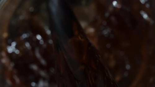 Top View, Pouring Carbonated Cola into a Glass, Macro Slow Motion.
