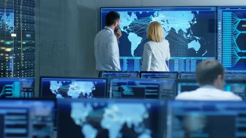In the System Monitoring Room Two Senior Operators Work on a Big Interactive Map. Facility is Full