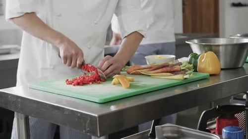 Chef Dicing Red Peppers in Commercial Kitchen