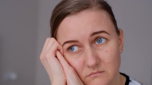 Woman Portrait Looking Sad Leaning on Hands Close Up