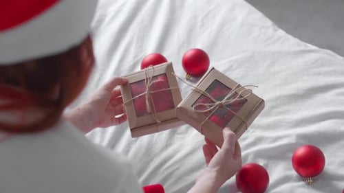 Woman Holds Holiday Gifts with Christmas Ornaments