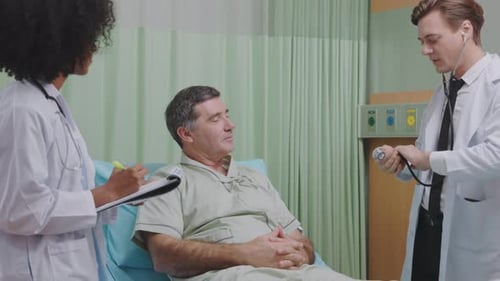 Doctor Examines Patient Respiratory System by Stethoscope in Hospital