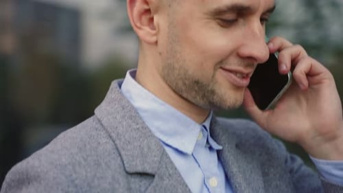 Smiling Businessman Talking on the Smartphone Outdoors Close Up Real Time