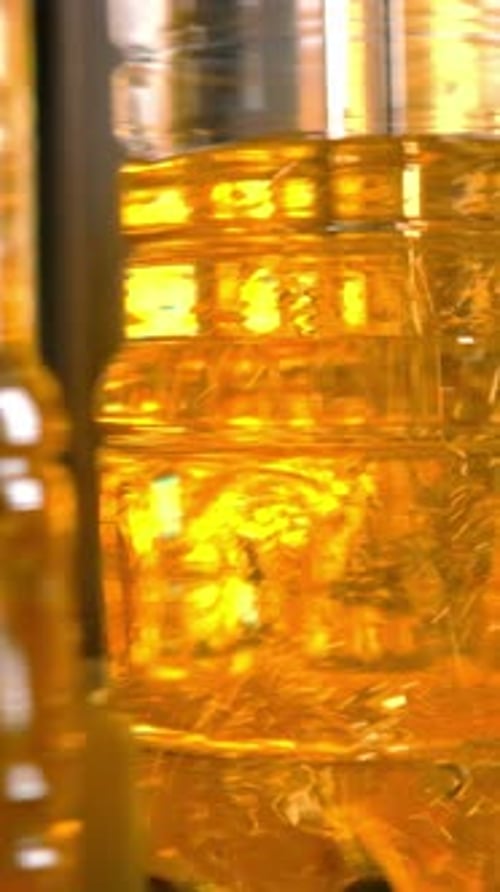 Closeup of Transparent Plastic Bottles Filled with Golden Liquid Showcasing Vibrant Colors and
