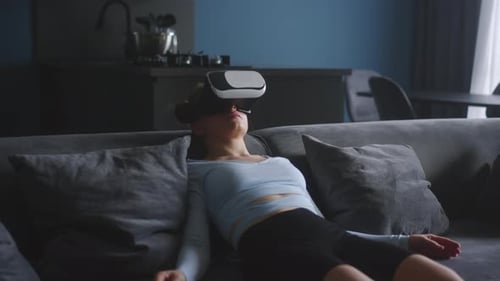 Woman Relaxing With Virtual Reality Headset on Couch