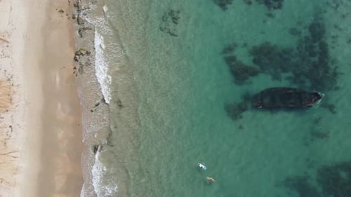 Aerial View Of Tourists Paddle Boarding By Shipwreck In Ocean - Arsuf, Israel