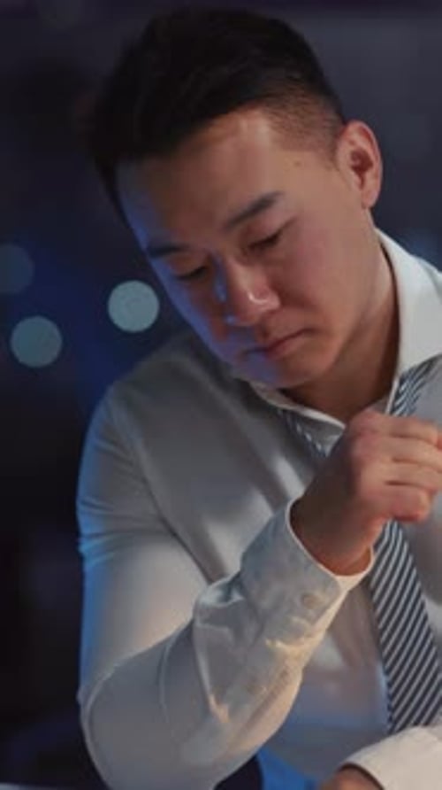 Frustrated Man Sitting at Desk Holding Head