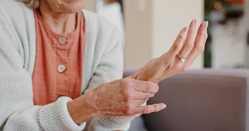 Senior Adult Woman Rubbing Her Wrist at Home