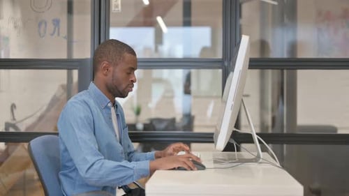 Man Working at Computer in Modern Office