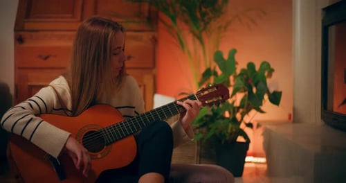 Woman Playing Acoustic Guitar at Home Composing Music Songwriting