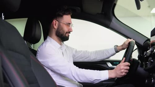 Funny Buyer Pretends to Drive a New Automobile in a Car Dealership