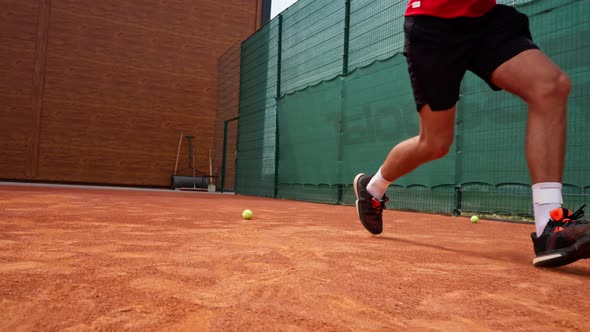 close-up of a tennis player's leg in dust on a tennis court who hits an ...