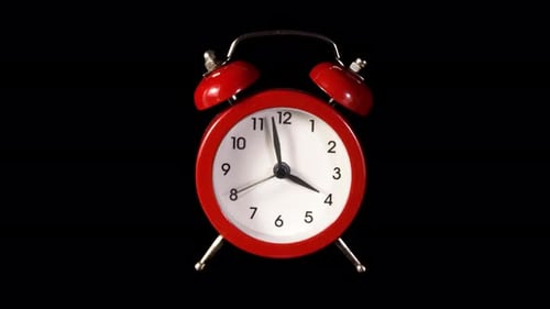 Red Alarm Clock Ticking Quickly on Black Background