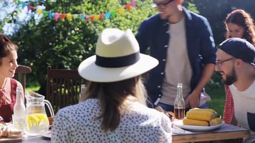 Friends and family gathered outdoors for summer barbecue
