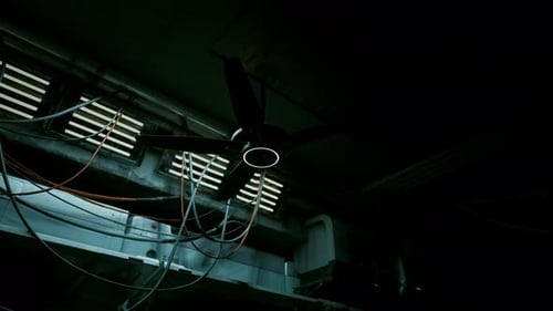 Dark Sci-Fi Industrial Room with Spinning Ceiling Fan