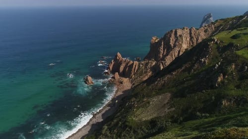 Drone footage of remote beach with its wide sandy coast. Sintra, Portugal
