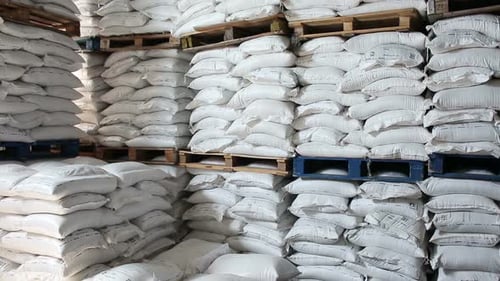 Warehouse full of white bags stacked on pallets