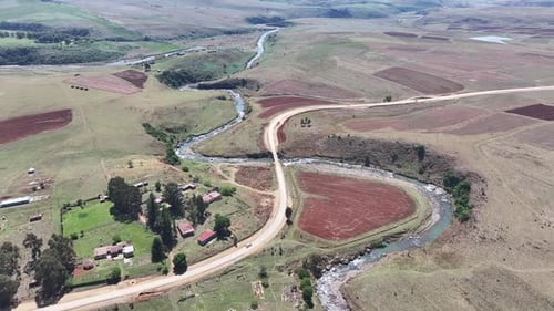 Dirt road winds through arid african landscape