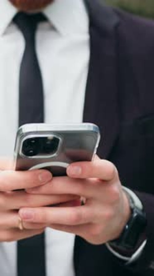 Close Up Serious Business Man Using Mobile Phone Outside Chatting Online and Commute with Male