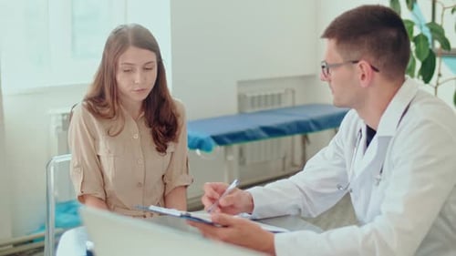 Woman Consults with Doctor in Bright Clinic Office