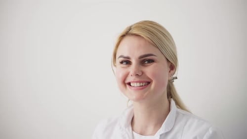Smiling Woman in White Coat Close Up