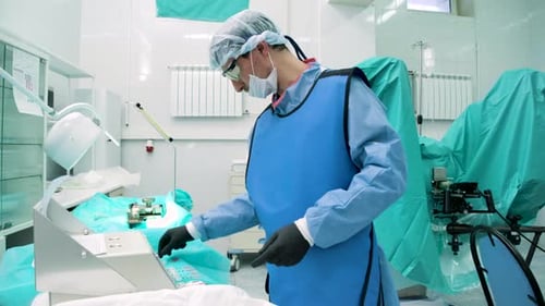 Surgeon Preparing Medical Equipment in Hospital Operating Room